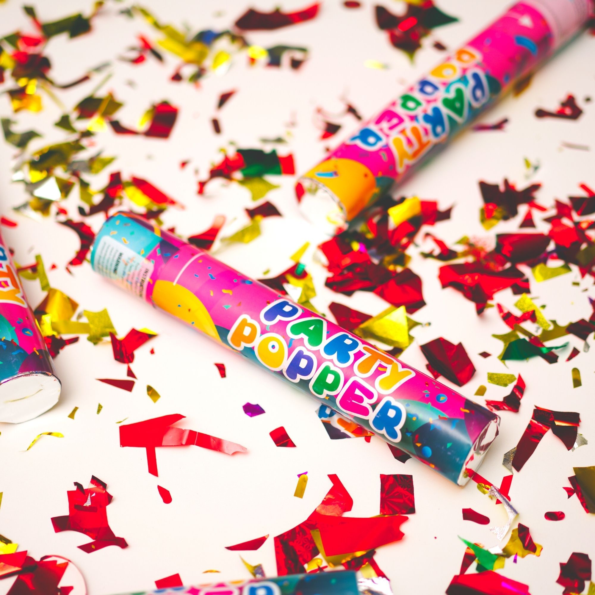 confetti cannon surrounded by red and gold confetti